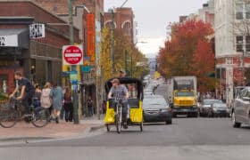 Downtown Asheville Street With Traffic and a Bike Taxi