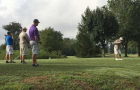 golfers on range for benefit