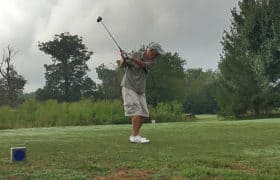 Man golfing for benefit